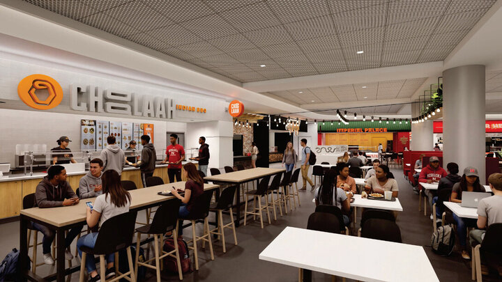 Food court with people dining and socializing, bright lighting, and visible restaurant signs.