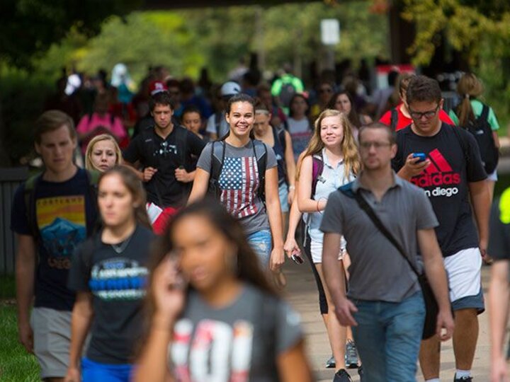 Group of students walking through campus