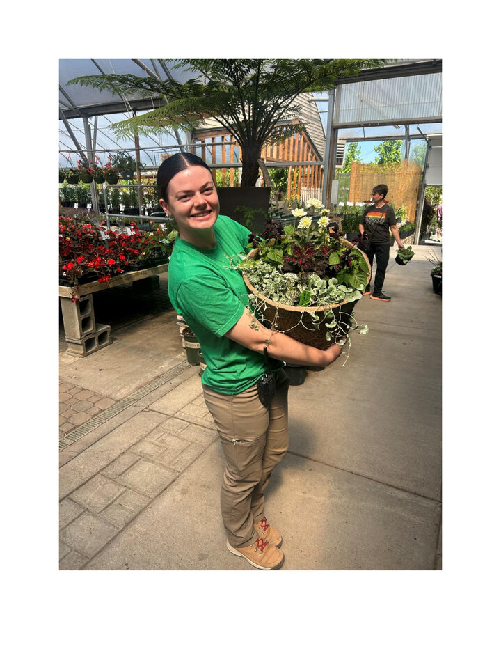 Emily holding a plant.