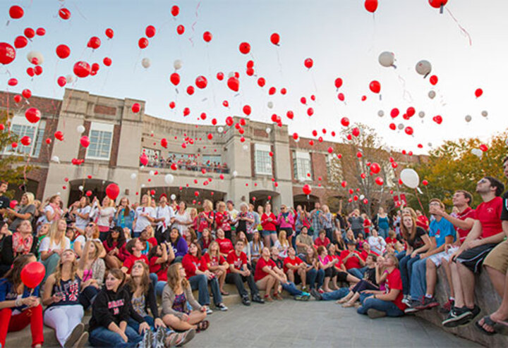 new student enrollment event with red balloons